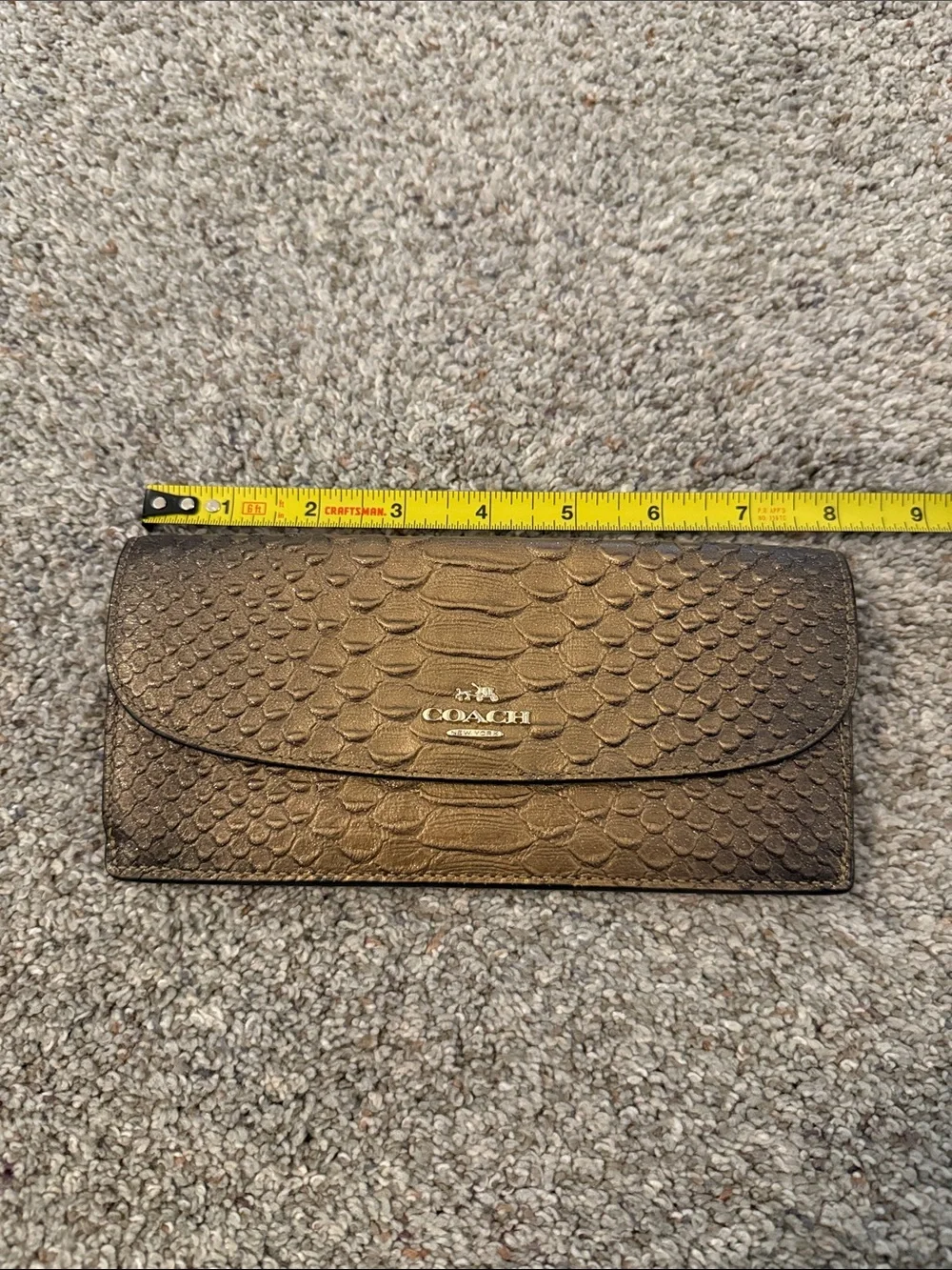 Coach Metallic snake-embossed leather envelope wallet in a muted gold tone